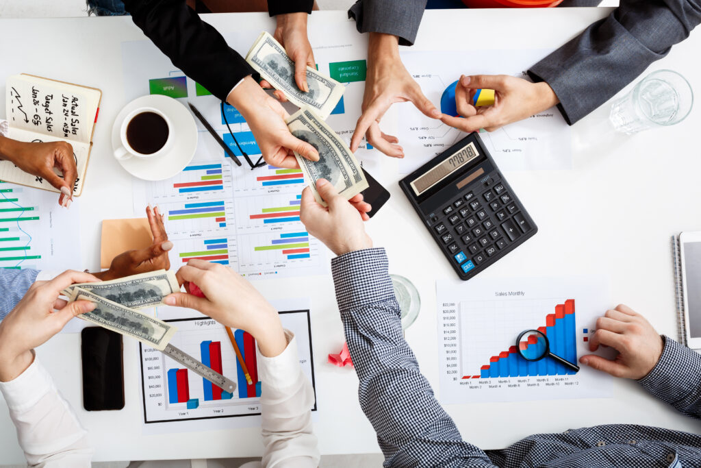 picture of businessmen's hands on white table with documents and drafts